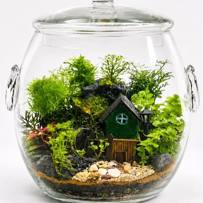 Closed terrarium jar with miniature cottage